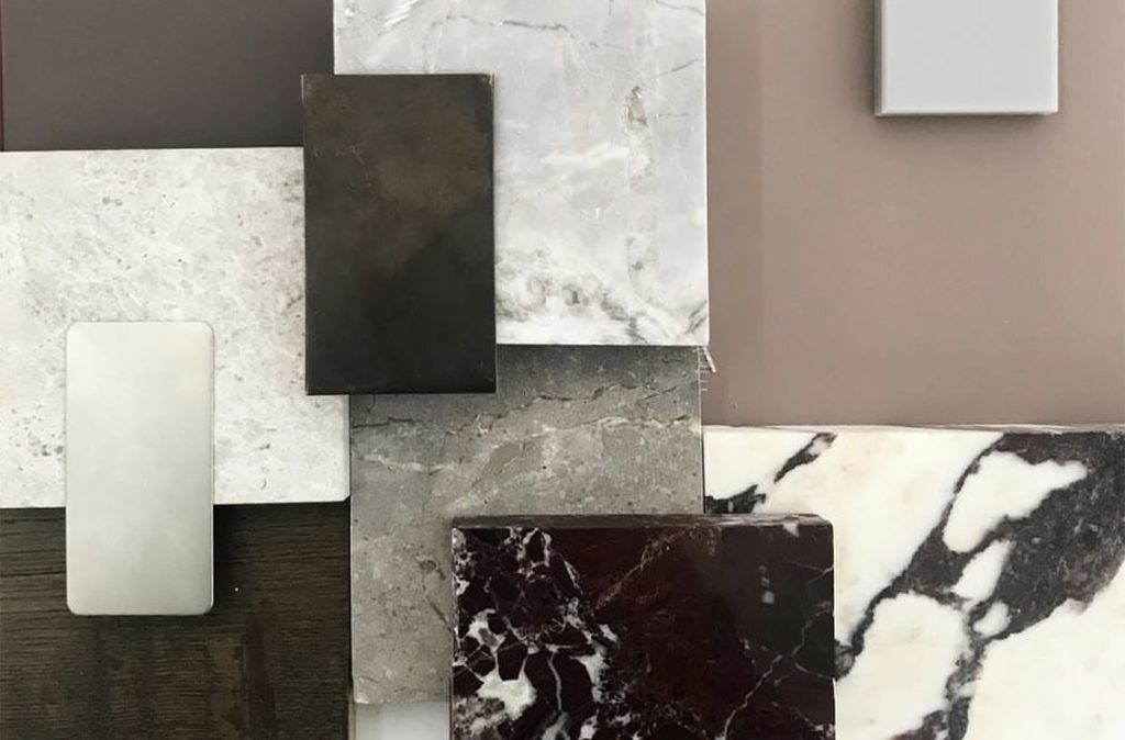 A group of premium quartz slab samples showing various colors and patterns. Features realistic marble-look, concrete-style, and solid color slabs for modern kitchen countertops, bathroom vanities, and commercial interior design. Durable, non-porous, and low-maintenance stone surfaces for your home or project.