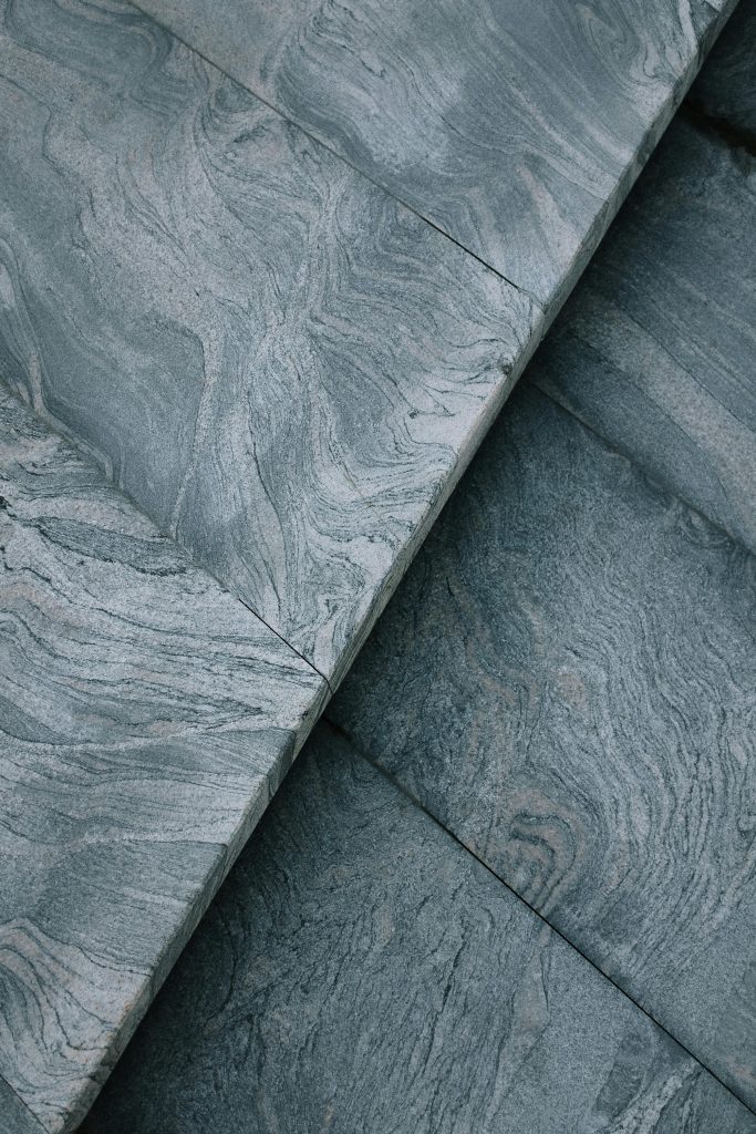 Close-up of a grey marble surface showcasing intricate natural patterns and textures.