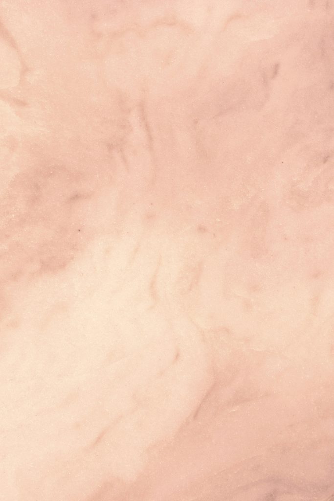 Subtle and elegant pink marble texture perfect for backgrounds or designs.