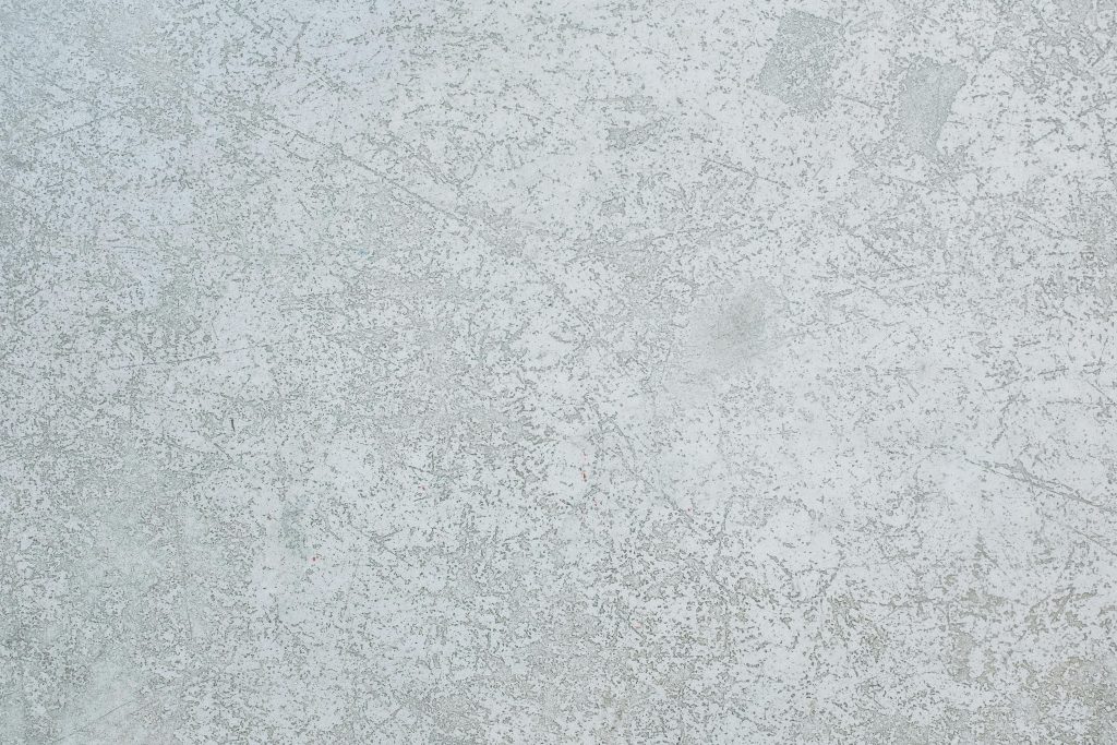 A detailed view of a textured grey concrete wall, perfect for use as a background or texture.