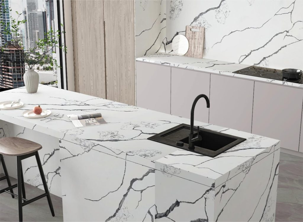 a kitchen counter of black branches quartz stone with a sink and a chair